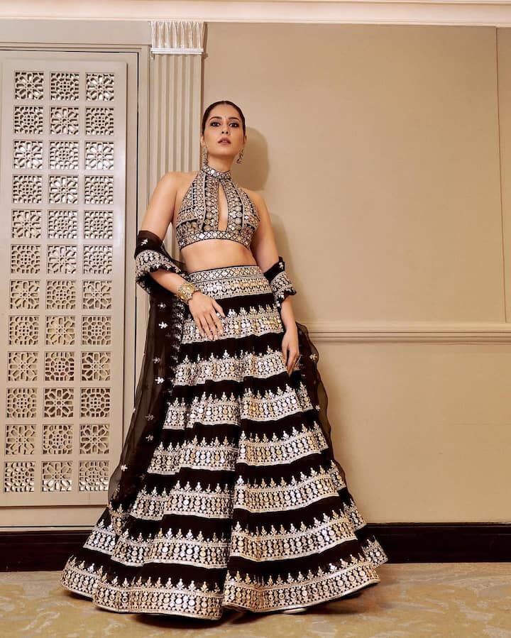 In the next picture you can see that the actress has worn a beautiful lehenga. You must recreate this outfit with heavy silver zari work on black base in the festive season. Halter neck blouse will add a modern twist to your traditional outfit.