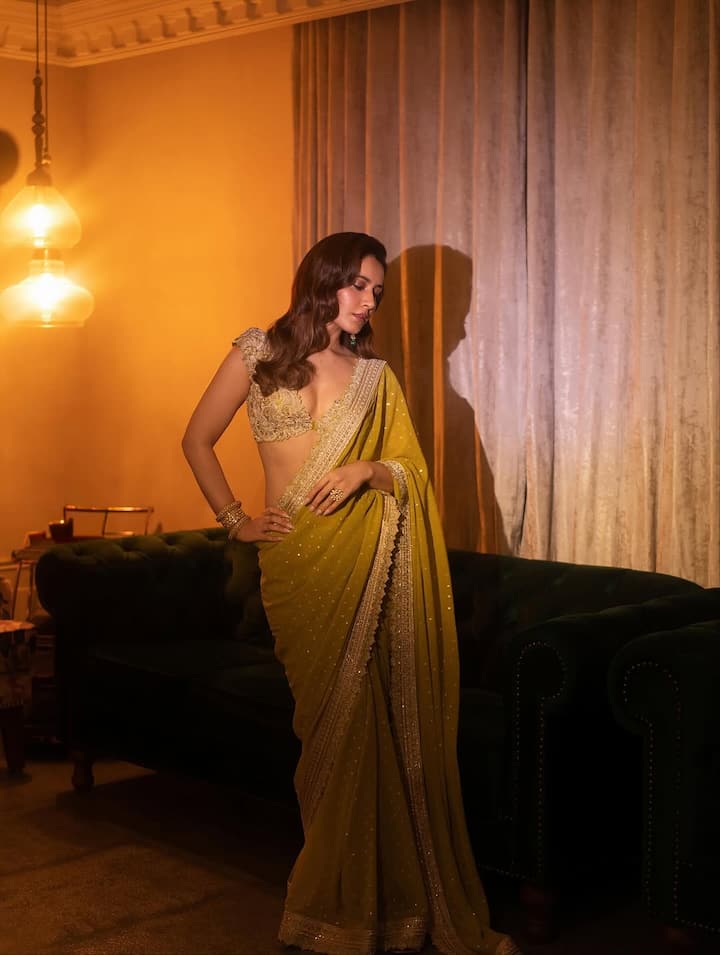 This olive gold saree of the actress is also perfect for the festive season. Like the actress, pair this saree with a deep cut embellished blouse. This look is perfect for festive parties.