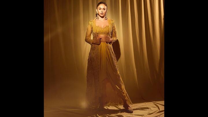 4. Golden-Yellow Embellished Ensemble: Rakul Preet lit up the festive mood in a stunning golden yellow embellished outfit. The actress radiated confidence, warmth, and glamour, making this one of her most memorable festive fashion moments. Her outfit featured a shimmering golden yellow silhouette with intricate embroidery and lace detailing, blending royal grandeur with modern sophistication. The fitted bodice, sheer sleeves, and flowing layered bottoms created a flattering structure. Rakul completed her look with bold earrings, sleek pulled-back hair, and soft gold-toned makeup, which allowed the outfit's luminosity to take the centre stage. (Image Source: Instagram/@rakulpreet)