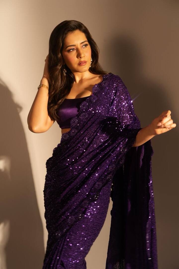 Violet Vision: End the celebrations on a dazzling note with Raashii’s purple sequin saree — pure festive drama! The sculpted blouse, soft curls, and glowing bronze makeup bring red-carpet glam to festive nights. Under golden lights, the outfit gleams like liquid amethyst, making it the ultimate finale look.