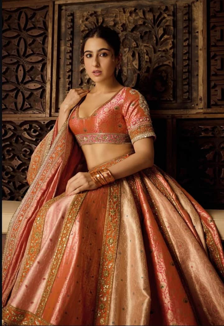From Lehengas To Sarees: Sara Ali Khan’s Best Ethnic Looks To Ace The Festive Season Lehenga Love Done Right: For those who want to sparkle like a true pataka this Diwali, Sara’s peach-orange lehenga is the ultimate inspiration. Adorned with intricate embroidery and golden borders, she styled it with a deep-neck blouse, minimal earrings, a sleek ponytail, and nude makeup — radiating effortless festive allure.