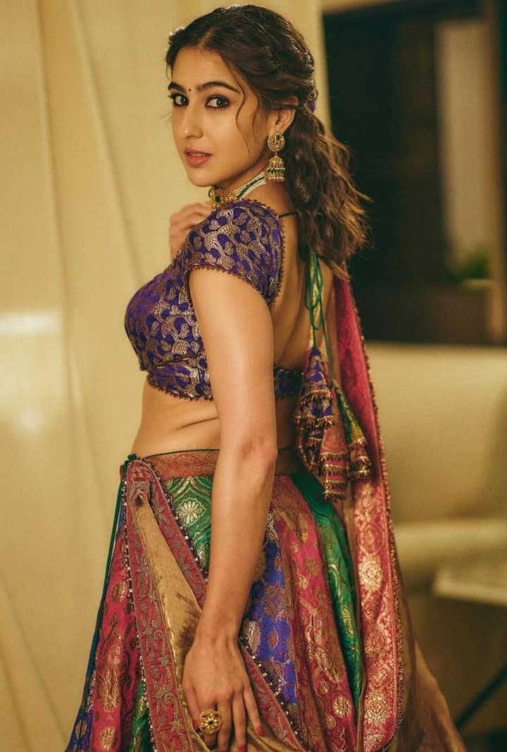 From Lehengas To Sarees: Sara Ali Khan’s Best Ethnic Looks To Ace The Festive Season Ethereal Beauty in Every Fold: Sara exudes ethereal charm in an exquisite lehenga crafted from vintage brocade sarees. The ensemble includes a deep purple backless blouse with dori ties and gota patti borders, teamed with a multi-hued brocade skirt and a tissue silk dupatta — a dreamy combination for festive elegance.