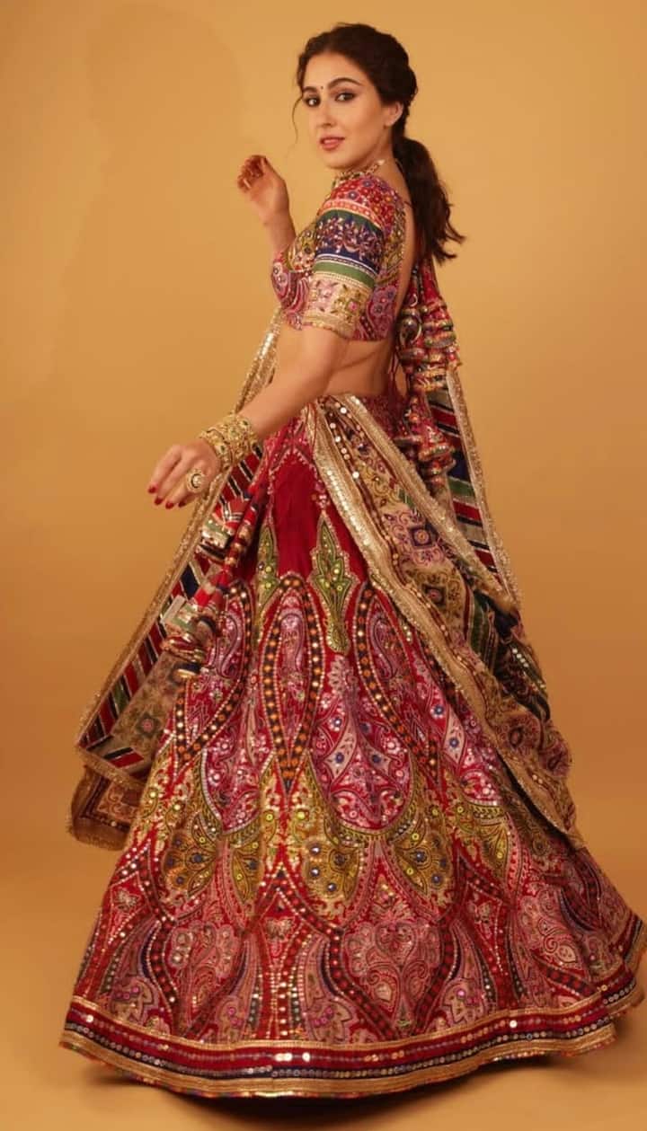 From Lehengas To Sarees: Sara Ali Khan’s Best Ethnic Looks To Ace The Festive Season Festive Flare with a Royal Touch: Sara turned heads in a pink Rajasthani-style ensemble featuring a heavily embroidered blouse with a sweetheart neckline, dori-tied back, and matching dupatta. Styled with traditional chooda bangles and a neatly braided ponytail, she embodied royal grace and festive elegance. (All Image: Special Arrangement)