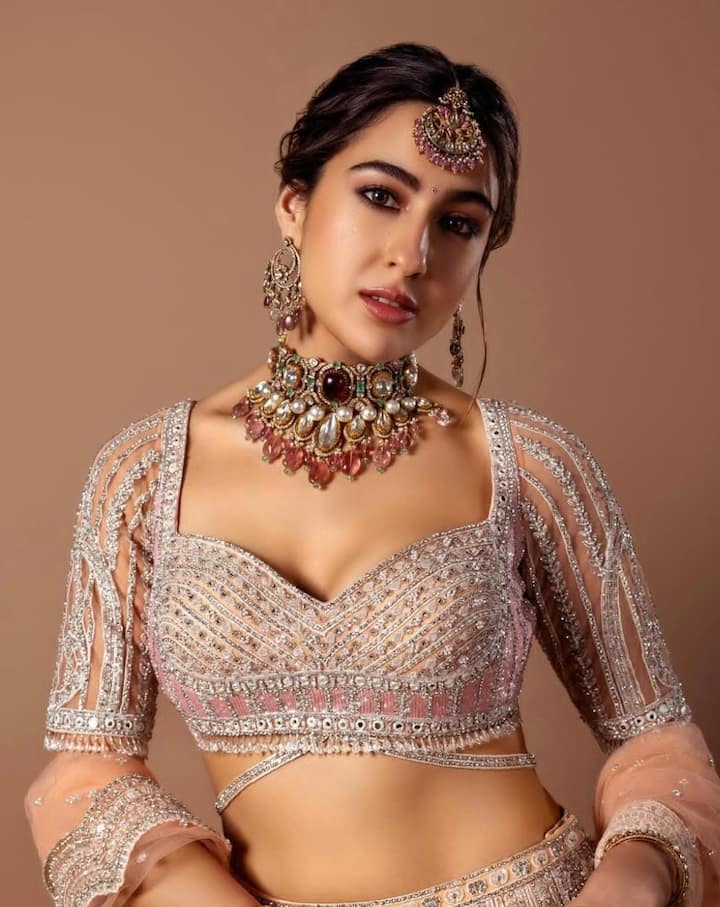 From Lehengas To Sarees: Sara Ali Khan’s Best Ethnic Looks To Ace The Festive Season All Eyes on the Ethnic Queen: Steal the spotlight this Diwali like Sara in a dazzling pink sequin lehenga set. The sweetheart-neck blouse, embellished with silver embroidery, mirror work, and pearl-drop tassels, paired with a shimmering gotta patti skirt, scalloped dupatta, and a statement choker, is pure festive magic.