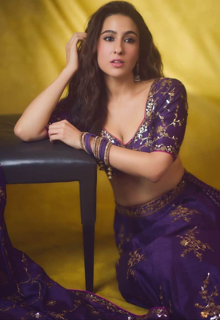 From Lehengas To Sarees: Sara Ali Khan’s Best Ethnic Looks To Ace The Festive Season Twirl-Worthy Festive Fits: Bring on the festive sparkle in a dark aubergine tissue lehenga like Sara’s, featuring intricate patra ka kaam, delicate dori accents, and golden embellishments. The wide-neck, half-sleeved blouse, paired with bangles and dainty jhumkas, makes it the perfect outfit to twirl through your Diwali parties.