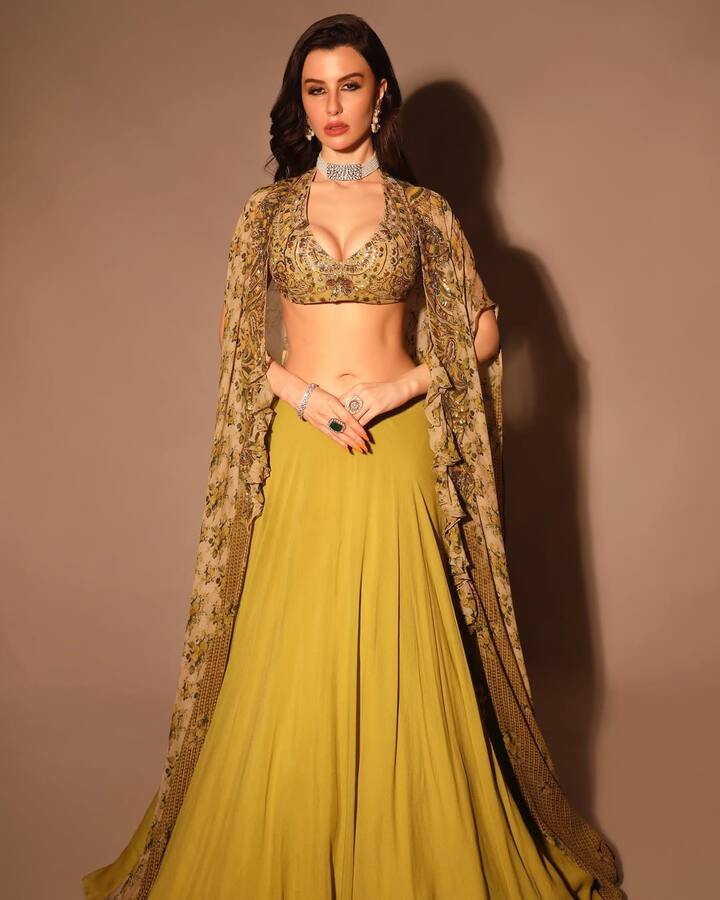 Georgia is looking very beautiful in this traditional look. She has worn a yellow colored lehenga which is quite stylish.