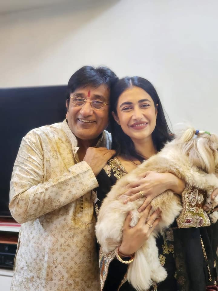 In one picture, Dhanashree is seen with her father and her pet dog. His father is wearing a cream colored kurta-pajama, which has print work on it. Dhanashree's smile while lovingly hugging her pet dog shows how special this Diwali has been for her.