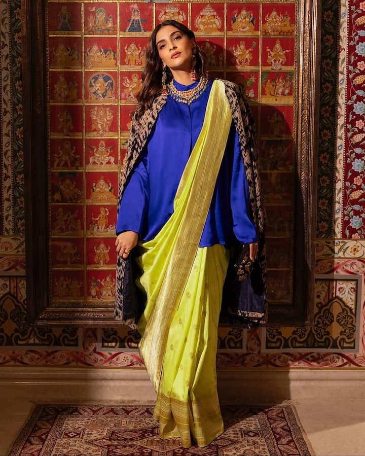 If you too are bored of wearing a blouse with a saree. So this look of Sonam Kapoor is a good option. You can carry such a silk shirt with any color saree. This will give you a very stylish look.