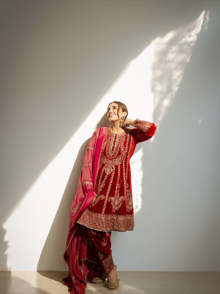 Huma Qureshi is looking very royal in this red color traditional suit with golden work.