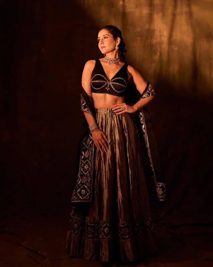 Raashii Khanna exudes regal elegance in her latest look, where she embraces a luxurious black-and-gold palette with a vintage cinematic vibe.