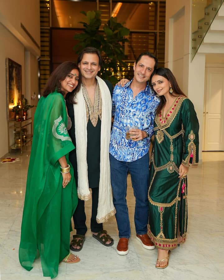His wife Priyanka Alva Oberoi is looking very elegant in a green colored saree. She completed her traditional style with minimal jewellery, open hair and simple makeup.