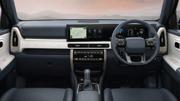 The new Venue also features a D-cut steering wheel and dual-tone interiors in dark navy and dove grey. Hyundai has added a ‘coffee-table’ style centre console with Moon White ambient lighting. Rear passengers now get a two-step recline, sunshades, and other comfort upgrades. (Image Credits: Hyundai)