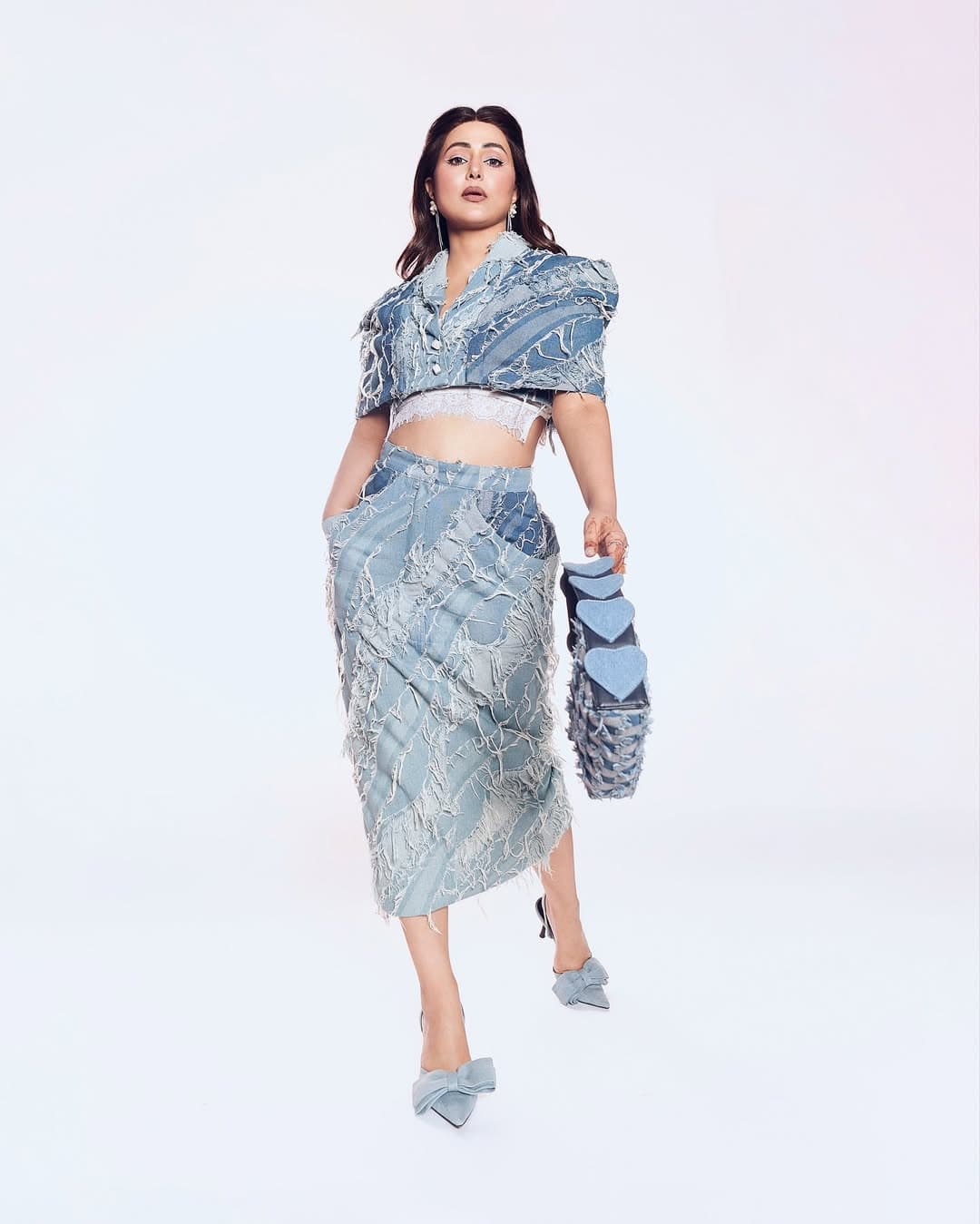 In this photo, Hina is seen in fashion-forward look. She is wearing a unique denim style outfit, which shows her style and fashion sense in a great way.