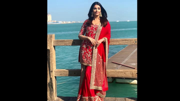 8. ⁠Red Embroidered Attire: Aishwarya Rai Bachchan paints Doha in shades of red with her breathtaking traditional look. The actress radiates timeless charm in a scarlet red embroidered suit featuring intricate golden threadwork and zari detailing, paired with a richly bordered dupatta and flared sharara. Aishwarya completes her look with statement jhumkas, sleek open hair, and her signature grace, proving once again that elegance never goes out of style. (Image Source: Instagram/@aishwaryaraibachchan_arb)