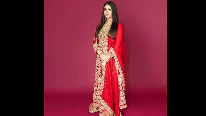 5. Regal Red Embroidered Suit: Aishwarya Rai Bachchan captivates in a royal red suit adorned with intricate gold embroidery, exuding timeless beauty and majestic poise. The rich red hue perfectly complements her radiant complexion, while the heavy zari detailing adds a touch of grandeur to the traditional ensemble. The floor-length silhouette, paired with a matching embroidered dupatta, highlights her effortless grace and signature sophistication. This look beautifully blends heritage craftsmanship with celebrity allure. (Image Source: Instagram/@aishwaryaraibachchan_arb)