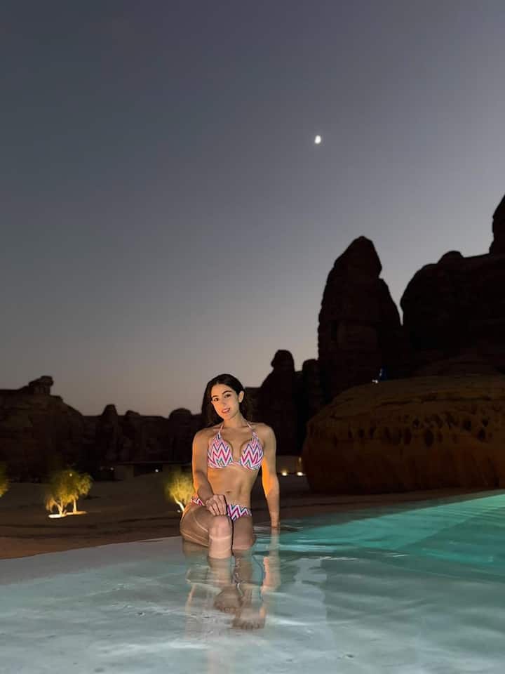In another frame, she amped up the glamour during a night pool session, donning a halter-neck bikini set featuring a colorful chevron pattern — radiating vacation confidence and fun.