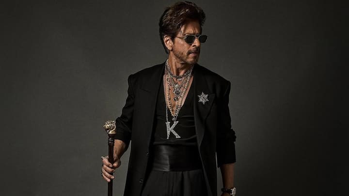 At his Met Gala debut, Shah Rukh commands attention in a dramatic long black overcoat, silk innerwear, and flowing trousers. Layered chains, a star-shaped brooch, and a cane add a royal, gothic flair, blending elegance with bold theatricality. (Image Source: Instagram/ sabyasachiofficial)