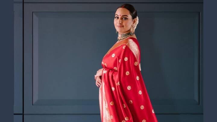 Sonakshi Sinha embraces traditional grace in this red silk saree with delicate gold butis and a rich zari border. Accentuated by her gajra bun, bold bindi, and emerald choker, she beautifully balances simplicity with regal poise for a festive-perfect look. (Image Source: Instagram/ aslisona)
