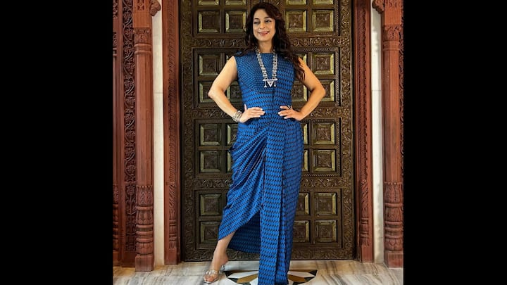 5. Blue Indo-Fusion Draped Saree Look: Juhi Chawla redefines elegance in a contemporary blue draped saree paired with a sleeveless blouse, blending traditional charm with modern minimalism. The geometric printed pattern adds texture and vibrancy, while the structured draping highlights her graceful silhouette. Styled with a chunky silver necklace and matching bangles, her accessories bring an ethnic edge to the fusion outfit. The metallic flats add comfort without compromising on chic appeal. This look perfectly captures the spirit of Indo-fusion fashion. (Image Source: Instagram/@iamjuhichawla)