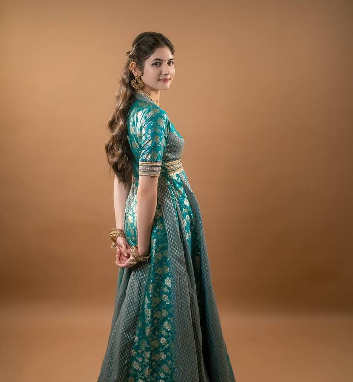 In this photo, Harshali is seen wearing Banarasi pattern Anarkali suit. To complete the look she has worn golden accessories. Harshali looks like Kamal in subtle make-up and curly hair.