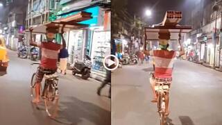 Video: ऐसा टैलेंट तो ओलंपिक में होना चाहिए! शख्स ने हैंडल पकड़े बिना सिर पर सामान रख चलाई साइकिल