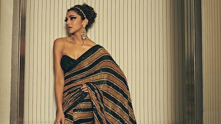 Deepika’s black-and-gold striped saree is perfect for a grand traditional function, blending shimmer with classic elegance. The structured strapless blouse and bold accessories give it a modern red-carpet twist while keeping the saree’s rich, festive appeal intact. (Image Source: Instagram/ deepikapdukone)