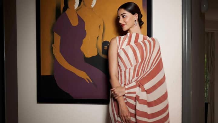 Ananya’s terracotta-and-ivory striped saree is a beautiful pick for intimate traditional gatherings. Its wide, soft stripes and fluid drape bring effortless grace, while the sleek styling adds a clean, contemporary touch. (Image Source: Instagram/ stylebyami)