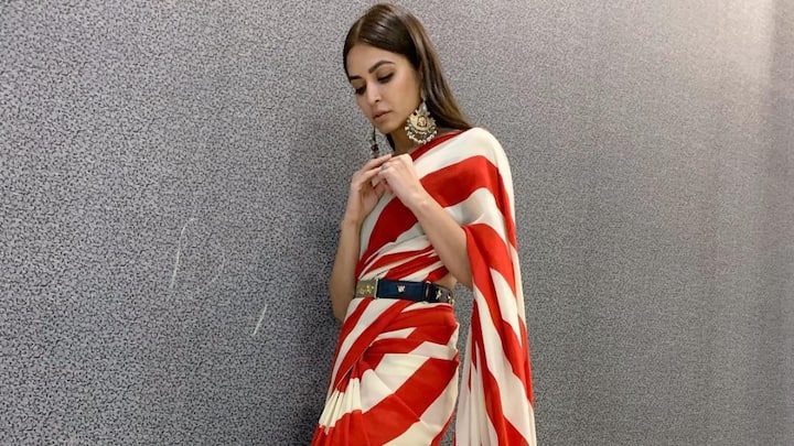 Kriti Kharbanda’s red-and-white striped saree offers a fresh, contemporary take on festive dressing. The diagonal stripes and waist-belt add definition and style, making it ideal for celebrations where you want a traditional yet fashion-forward look. (Image Source: Instagram/ kriti.kharbanda)