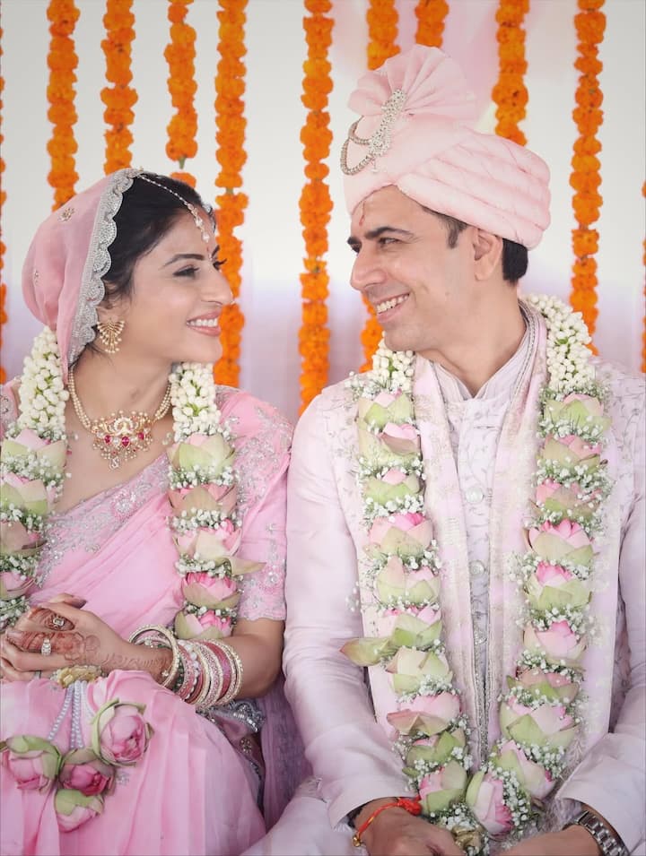 The newly released wedding portraits, shared on Instagram, capture the couple glowing in soft pastel pinks, their expressions radiating joy and gratitude as they step into married life.