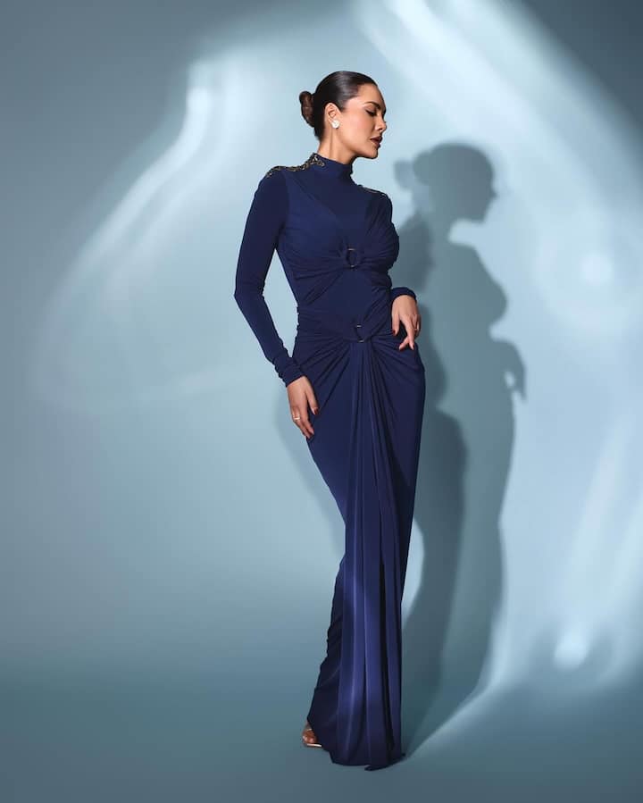 ఈ ఫోటోలో ఈషా గుప్తా నీలం రంగు ఫుల్ స్లీవ్స్ బాడీకాన్ డ్రెస్ ధరించి కనిపించారు. ఆమె లైట్ మేకప్ వేసుకుని, జుట్టు ముడి వేసుకుని ఉన్నారు.