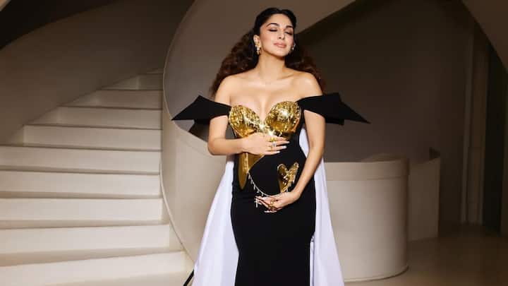 Kiara Advani’s Met Gala debut became an empowering celebration of motherhood. Wearing a custom Gaurav Gupta black gown with an antique gold-plated breastplate adorned with ghungroos and crystals, she blended Indian elements with futuristic design. A gold-plated heart placed on her baby bump, connected by a chain symbolising the umbilical cord, made the moment unforgettable. (Image Source: Instagram/ kiaraaliaadvani)