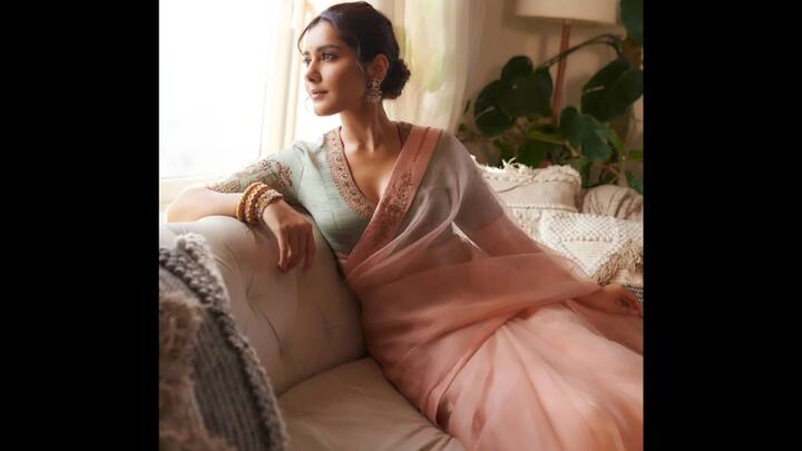 5. Pastel Peach And Sage Green Look: Raashii Khanna serves pure elegance in this breathtaking pastel peach and sage green saree, creating a look that’s soft, serene and impossibly graceful. The lightweight sheer drape flows beautifully, giving the outfit a dreamy, almost poetic feel. The highlight of the look is the sage green blouse, adorned with intricate floral embroidery along the neckline and sleeves. The delicate craftsmanship enhances the saree’s understated charm, while the V-neck silhouette adds a modern, feminine touch. Raashii completes the look with statement earrings, stacked bangles and a neatly tied bun, letting her natural glow shine through. (Image Source: Instagram/@raashiisheaven)
