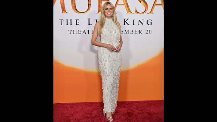 1. Heidi Klum: Heidi Klum wore a show-stopping Waterfall Pearl Gown. he supermodel and TV personality embraced old-Hollywood luxury with a modern twist, wearing a breathtaking halter-neck creation crafted with over 100,000 pearls and crystals, each meticulously placed to create a luminous, liquid-like effect under the lights. The sleeveless, halter silhouette offered an elegant, elongated shape, allowing the gown’s craftsmanship to take centre stage. Its intricately embellished base, densely packed with delicate pearls and shimmering crystals, formed the first layer. Over this base, designers added a cascade of pearl tassels, creating a second layer that draped and moved like flowing water. Every tassel was hand-sewn to perfection, giving the gown its signature “waterfall” effect. (Image Source: Instagram/@manishmalhotraworld)