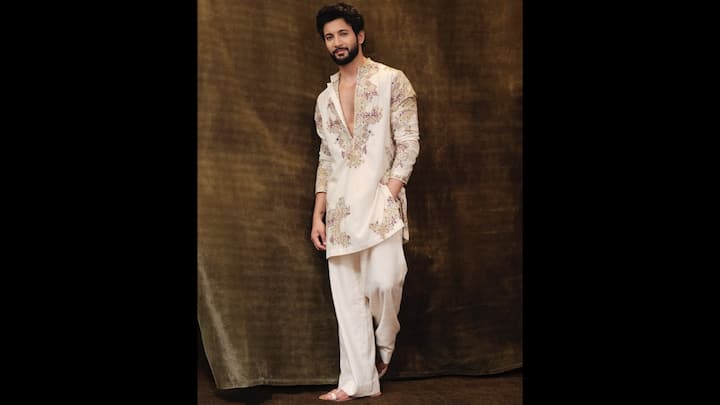8. ⁠Ivory Embroidered Kurta: Rohit Saraf steps out in a stunning ivory embroidered kurta set that blends minimalism with high-fashion detailing. The kurta features soft pastel embroidery in lavender, sage, rose and muted gold, arranged in symmetrical, regal patterns that instantly elevate the outfit. The craftsmanship stands out without overpowering the look. Paired with straight ivory trousers, the outfit maintains a fluid, monochromatic flow that photographs beautifully. The white Kolhapuri chappals tie the entire look together, leaning into the new wave of understated luxury dressing for men. (Image Source: Instagram/@rohitsaraf)