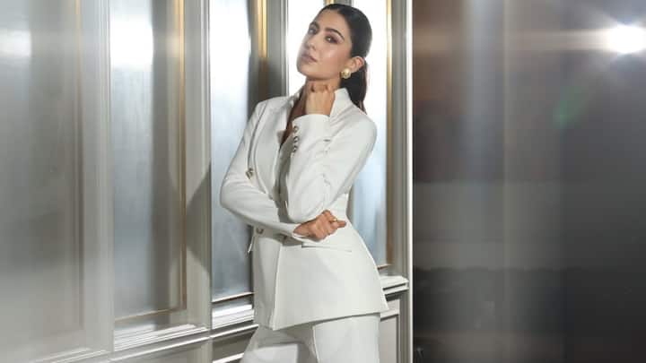 Classic Blazer Suit With Golden Buttons: Sara Ali Khan wore a low-collared V-neck blazer adorned with golden buttons, styled with straight white trousers for a clean, office-friendly look. Silver heels and nude makeup kept the ensemble effortlessly refined. (Image Source: Instagram/ saraalikhan95)