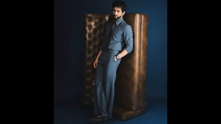 4. ⁠Monochrome Steel-Blue Suit: Rohit Saraf delivers a masterclass in refined menswear with this steel-blue monochrome suit, effortlessly blending sharp tailoring with contemporary elegance. The outfit features a perfectly coordinated steel-blue shirt paired with matching tailored trousers, creating a polished, uninterrupted silhouette. Adding to the sleek aesthetic, Rohit opts for a tonal tie in the same blue palette, reinforcing the minimalist direction of the look. The ensemble is grounded with smart black formal shoes, adding contrast without disrupting the overall monochromatic colour story. A bold wristwatch injects a touch of personality, making the look both camera-ready and effortlessly stylish. (Image Source: Instagram/@rohitsaraf)