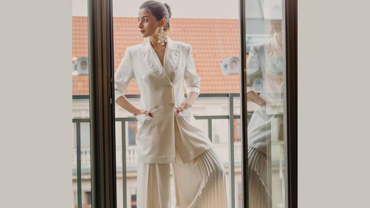 Relaxed Blazer With Pleated Pants: Alia Bhatt kept things understated yet chic with a sleek blazer featuring wide lapels and folded sleeves, teamed with flared pleated pants. Pearl chandeliers and minimalist makeup added soft sophistication. (Image Source: Instagram/ aliaabhatt)