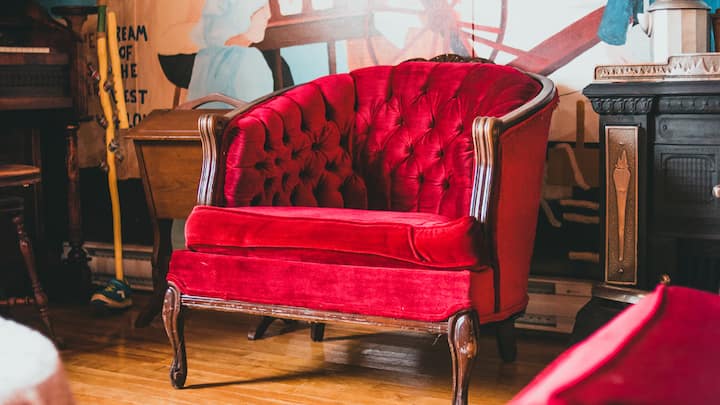 Velvet Armchairs: Velvet has a way of making a room feel soft and luxurious. A deep green or warm red armchair can turn a corner into a cosy nook. Add a small throw or a cushion, and suddenly you have the perfect spot to enjoy a cup of cocoa while watching the lights. (Image Source: Canva)