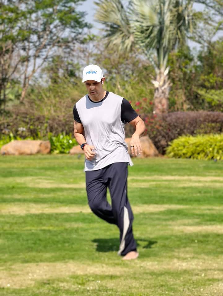 Hrithik Roshan has shared pictures of himself and his sons Rehaan and Hridhaan on his Instagram. In the first photo, the actor is seen running barefoot on the grass wearing a T-shirt, trousers and a hat on his head.