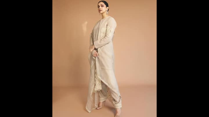 2. ⁠Timeless Elegance In Minimal Ivory Kurta Set: Deepika Padukone’s fashion choices often balance glamour with grace, and this ivory ethnic ensemble is a perfect example of her understated yet powerful style sensibility. The look features a straight-cut ivory kurta adorned with delicate floral and geometric embroidery, lending the outfit a soft, handcrafted appeal. Paired with matching pants and a sheer dupatta edged with intricate detailing, the ensemble exudes quiet luxury. Styling remains clean and intentional. Deepika opts for sleek hair pulled back, statement earrings, and neutral makeup with softly defined eyes, a combination that complements the outfit without overpowering it. (Image Source: Instagram/@deepikapadukone)