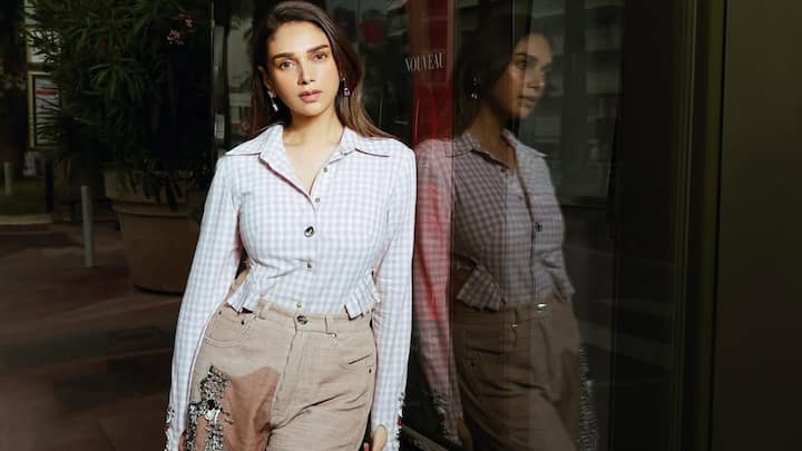 Aditi Rao Hydari keeps it effortlessly elegant in this pastel-checked fitted shirt paired with high-waisted beige trouser. Subtle detailing and a soft colour palette make the look relaxed yet refined—ideal for polished daytime outings. (Image Source: Instagram/ aditiraohydari)