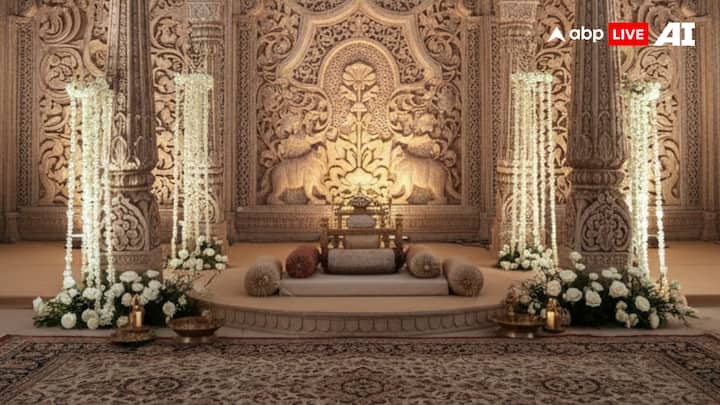 2. Heritage Arches & Royal Backdrops - Palace Motifs Reimagined: Inspired by India’s regal past, heritage-led mandaps draw heavily from palace architecture, ornate backdrops, and royal motifs. Think carved columns, layered arches, antique mirror panels, stained glass accents, floral torans, and vintage brass lanterns, all coming together to create a grand sense of arrival. Guests often enter through a sequence of archways, echoing palace courtyards and durbar halls. References to Udaipur’s City Palace, Mughal arches, lotus domes, carved pillars, marigold cascades, and gota patti detailing bring an unmistakable royal narrative to the mandap, creating a setting worthy of a modern-day royal ceremony. (Image Source: ABP Live AI)
