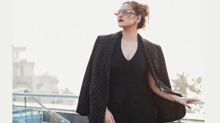 Black-on-Black Statement Styling: Draping a polka-detailed black blazer cape-style over a sleek monochrome base, Sonakshi delivers bold power dressing. The tailored structure and deep neckline create a commanding yet modern silhouette. (Image Source: Instagram/ aslisona)