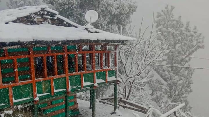 A scenic view of Harsil Valley emerges amid continuous snowfall in Uttarkashi, with snow-laden trees and mountains highlighting Uttarakhand’s pristine winter beauty. (Image Source: PTI)