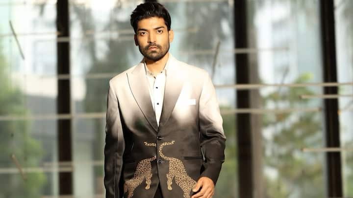 Ombre Drama with A Wild Edge: His ivory-to-black ombré blazer stands out with a striking gold leopard motif, blending classic tailoring with artistic flair. Styled with a crisp white shirt and slim black trousers, the look feels polished yet fashion-forward. (Image Source: Instagram/ guruchoudhary)