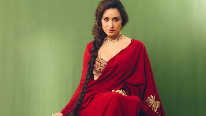 Classic Red Saree With Gold Blouse: Shraddha radiates timeless royalty in a rich red saree paired with a structured gold-embroidered blouse. A sleek side braid, soft glowing makeup, and delicate gold jewellery elevate the monochrome elegance. The look feels regal, graceful, and effortlessly cinematic. (Image Source: Instagram/ shraddhakapoor)