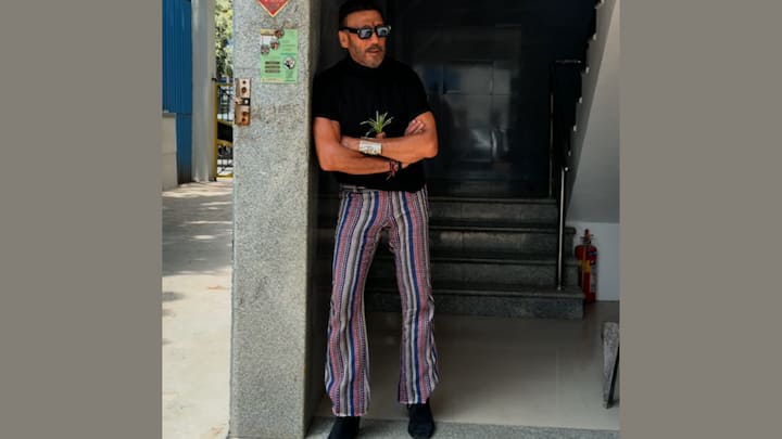 Jackie Shroff once again turned heads with his effortlessly bold fashion game. Dressed in a fitted black T-shirt with striped boot-cut trouser, the actor brought retro vibes with a modern street-style twist. His sunglasses, rugged boots, layered accessories, and signature plant detail added a quirky touch that perfectly reflected his fearless personality.