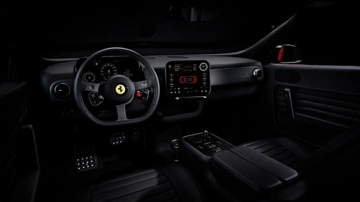Ferrari still avoided an all-touchscreen setup by keeping physical controls, including a glass gear selector, steering toggles, and traditional-style driver controls for a sporty feel.
