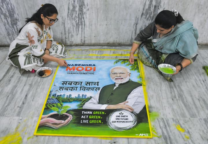 Women prepare an eco-themed rangoli as part of the celebration ahead of Prime Minister Narendra Modi's visit to the Indoor Stadium, in Surat. (Image Source: ANI)