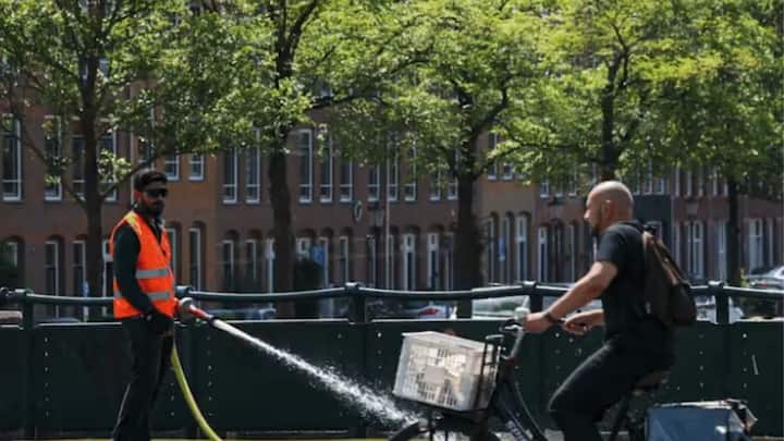 Workers are hosing down roads across parts of Europe to cool overheated surfaces during the 45°C heatwave.